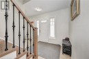 Foyer with stairway and light tile patterned floors Foyer with stairway and light tile patterned floors