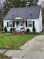 Single story home featuring a front yard and covered porch