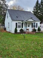 View of front facade with a front lawn and a porch