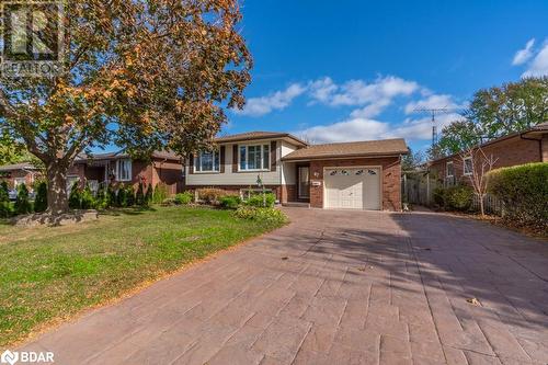 Split level home with a garage and a front yard