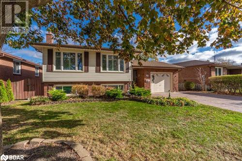 Split level home with a garage and a front yard