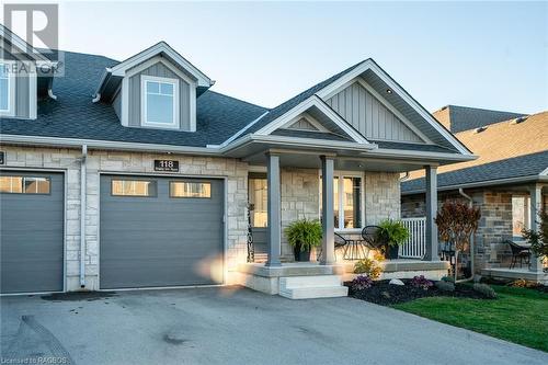 View of front of house featuring a garage and a porch