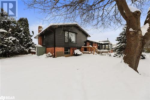 View of snow covered back of property