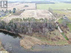 Birds eye view of property with a rural view and a water view