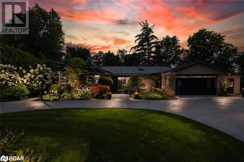 View of front of home with a garage and a lawn