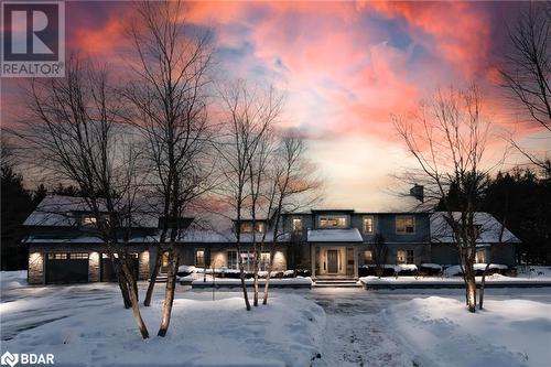 View of front of home with a garage and stone siding