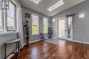 This room has 2 skylights and an exit to the back!