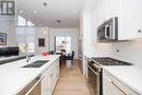 White quartz counters, gold hardware
