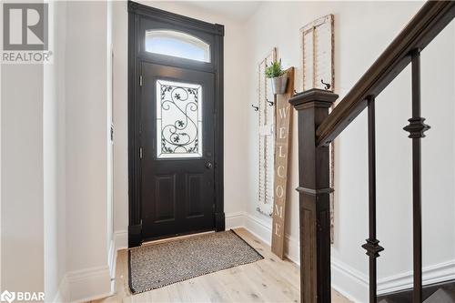 Entrance foyer featuring baseboards and light wood finished floors