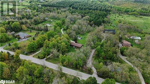 Aerial view of property and surrounding area featuring a heavily wooded area