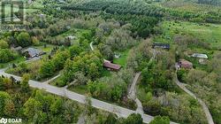 Aerial view of property and surrounding area featuring a heavily wooded area