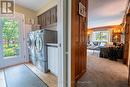 Main floor laundry features pocket door...