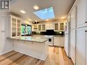 Custom open kitchen with skylight & water views.