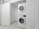 Stacked washer & dryer in front double closet