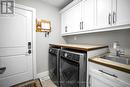 Main floor laundry with cabinets above