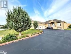 View of front of home featuring a garage and a front lawn