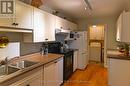 KITCHEN WITH LAUNDRY ROOM IN BACKGROUND.