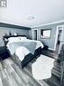 Bright Primary Bedroom.   Laminate Floors.