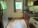 Galley Kitchen with W/O to Back Yard in Apartment