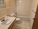 4 pc bathroom with tile floor and walls