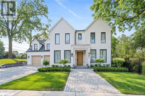 View of front of home featuring brick siding, decorative driveway, and a garage