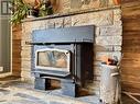 Stone fireplace w/efficient airtight wood insert.