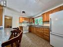 Enter the large wood cabinetry kitchen.