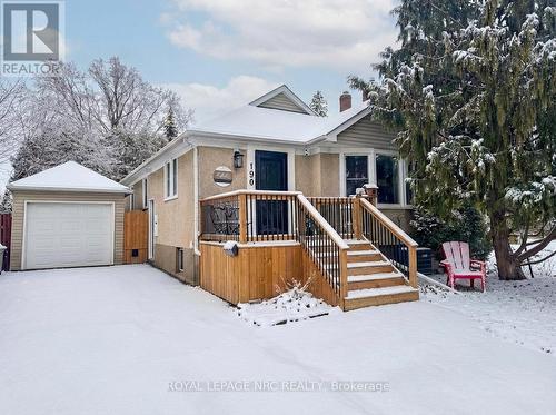 Long paved drive leads to detached single garage