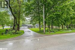 View of front of home with a front lawn and asphalt driveway