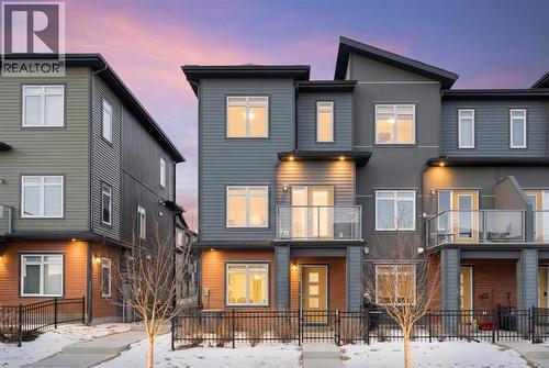 Front view, balcony, fenced concrete patio, poured concrete walk