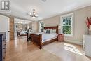 Bright Primary Bedroom Offering Hardwood Flooring