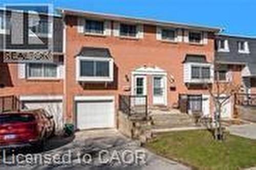 Multi unit property featuring driveway and a garage