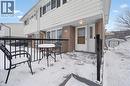 Snow covered patio with a storage shed