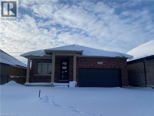 Single story home featuring brick siding and an attached garage