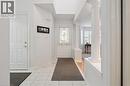 Entryway with light tile patterned floors and baseboards