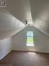 upstairs,featuring sloped ceilings,carpeted flooring