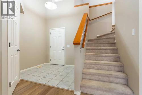 Large tiled entrance, vaulted ceiling, walk-in entrance closet, stairs to upper level
