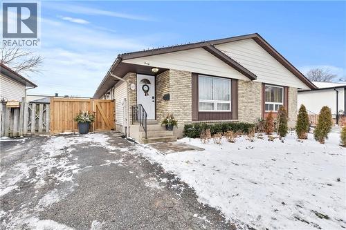 View of front of property with brick siding and a gate