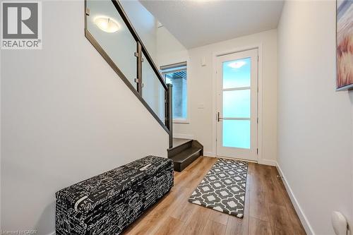 Entryway with stairs and wood finished floors