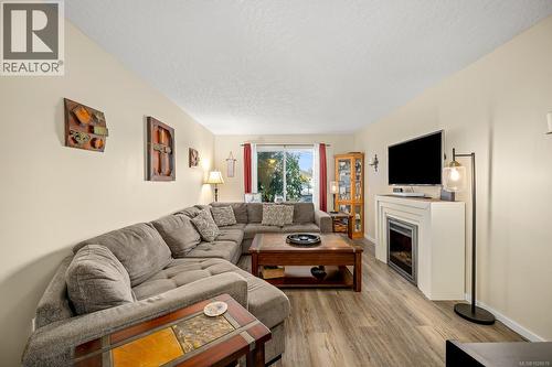 Living area with laminate flooring and electric fireplace