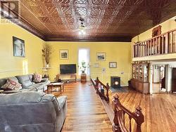 Great room w/ refinished hardwood and pellet stove