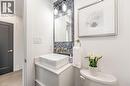 Mainfloor Half bathroom with backsplash and vanity