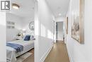 Hallway with light wood-style floors and recessed lighting