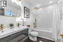 3rd Bathroom (2nd floor Family) featuring double vanity, shower / bath combo with shower curtain, dark tile patterned floors, and recessed lighting