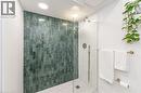 4th bathroom (basement) with a stall shower, vanity, and tasteful backsplash