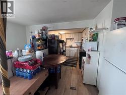 Kitchen featuring white appliances, light wood finished floors, and light countertops