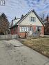 Bungalow-style home featuring brick siding and a chimney