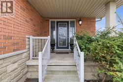 Entrance to property featuring brick siding and covered porch