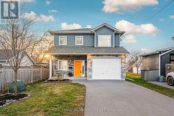 Covered Porch, 1.5 Car Garage & Paved Driveway