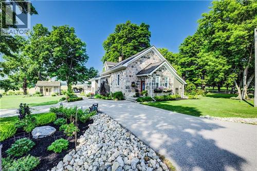View of front of property with stone construction and front yard